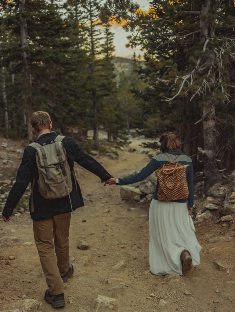 a couple walking down a hiking path for their elopement
