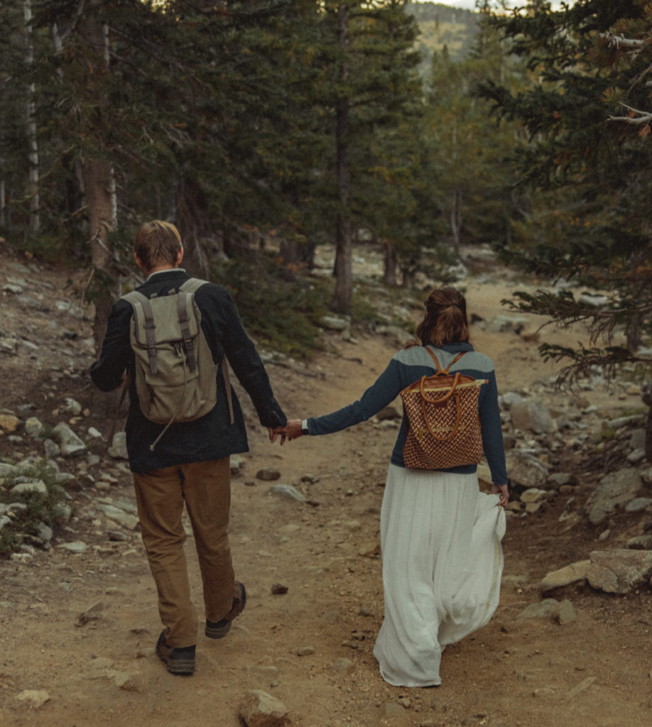 A guide to eloping while hiking down a path in wedding attire. 