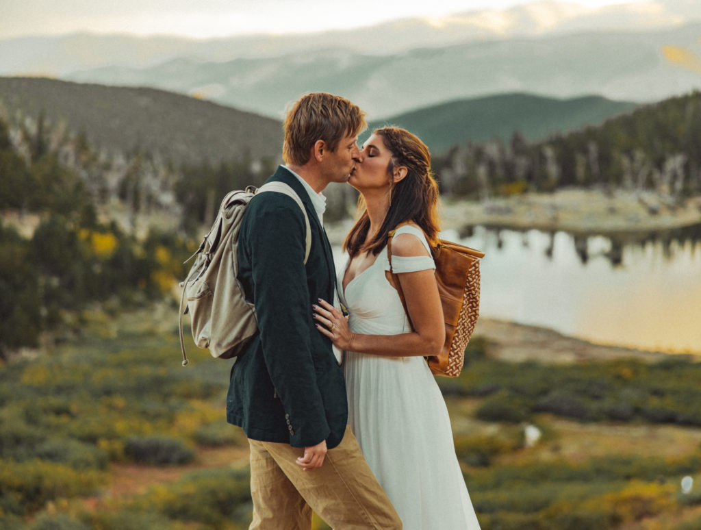 a couple kissing during elopement with a mountainous view
