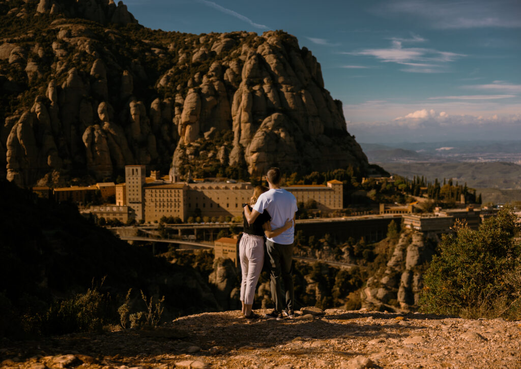 Couple standing on cliff edge in Montserrat, Spain at the Abbey of Montserrat
