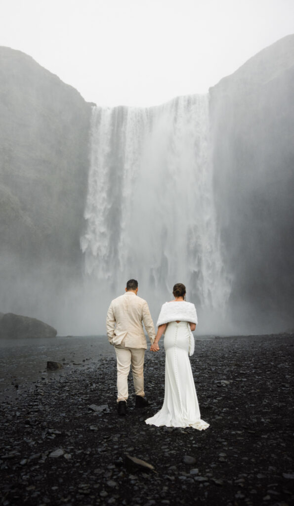 a couple eloping at Skógafoss falls in iceland