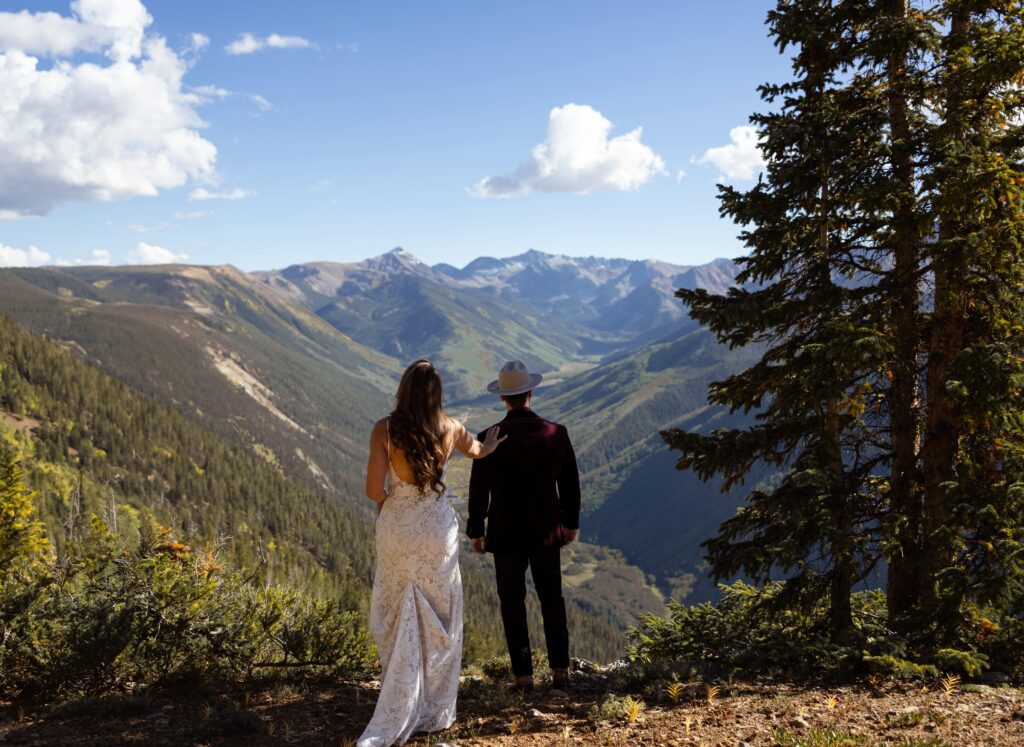 a couple doing their first look on top of a mountain in aspen colorado