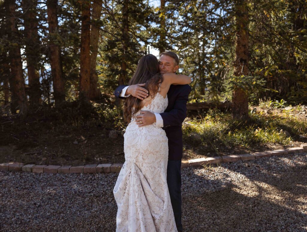 Groom wiping away tears during emotional first look
