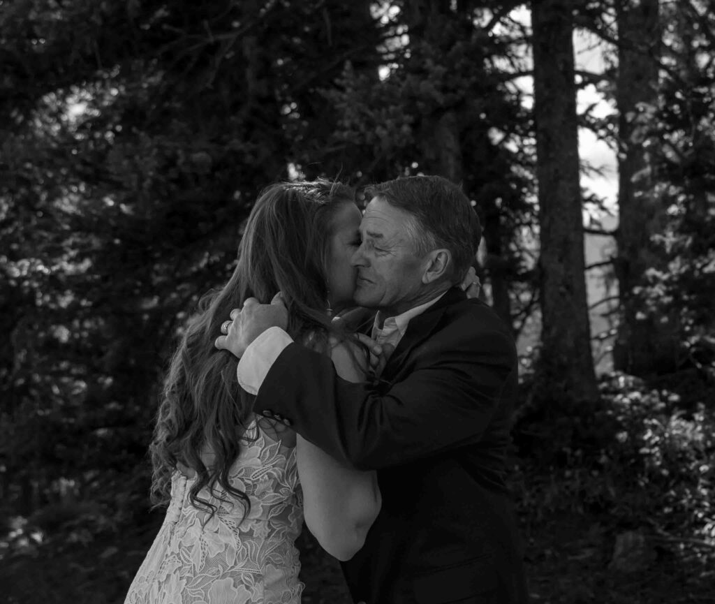 Bride and groom holding hands with a stunning Aspen mountain backdrop
