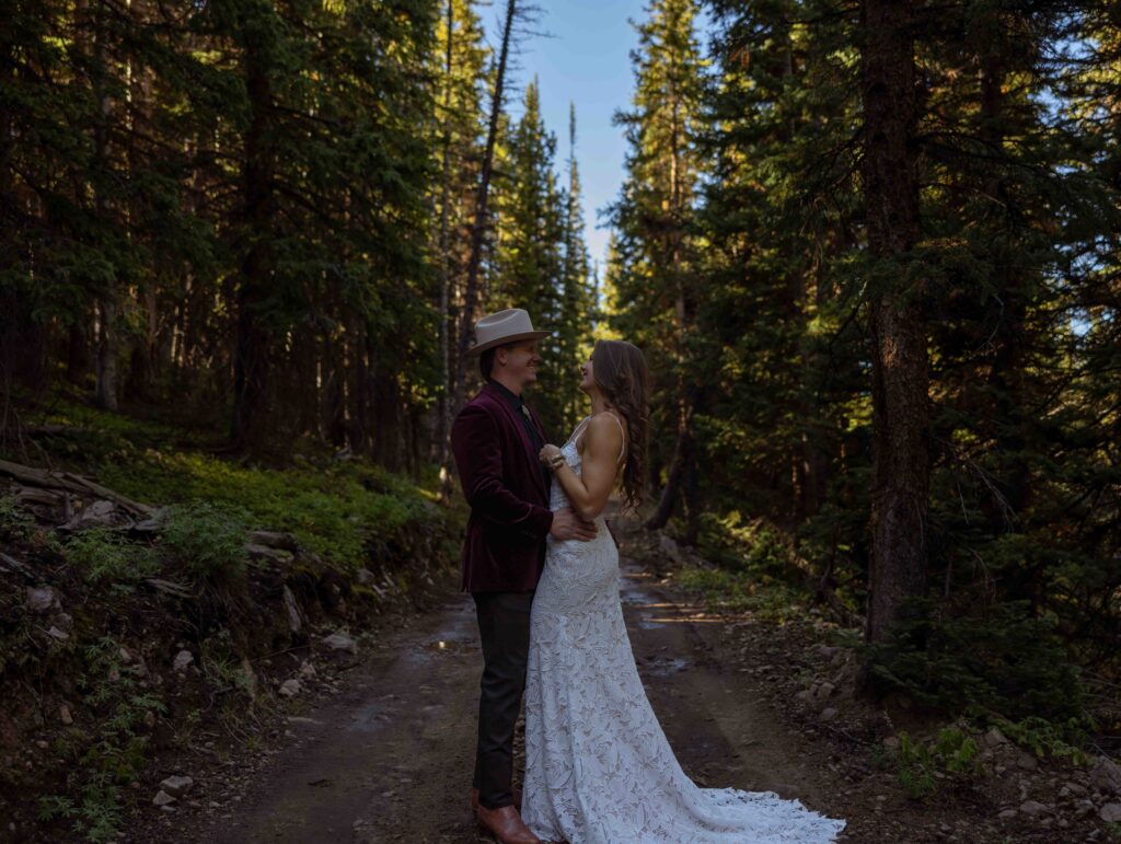 Sunset portrait of the newlyweds with golden mountain light
