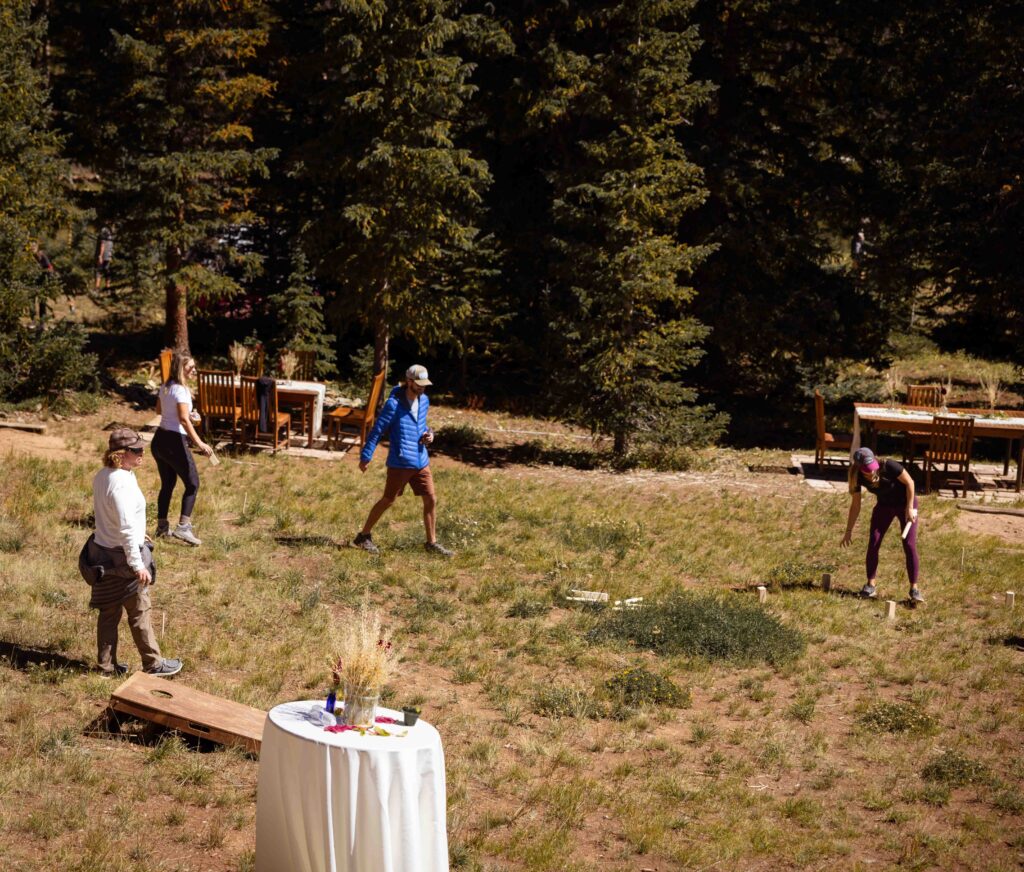 Groom throwing a bean bag during a friendly game with guests
