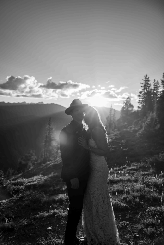 Groom holding the bride close as they take in the breathtaking view
