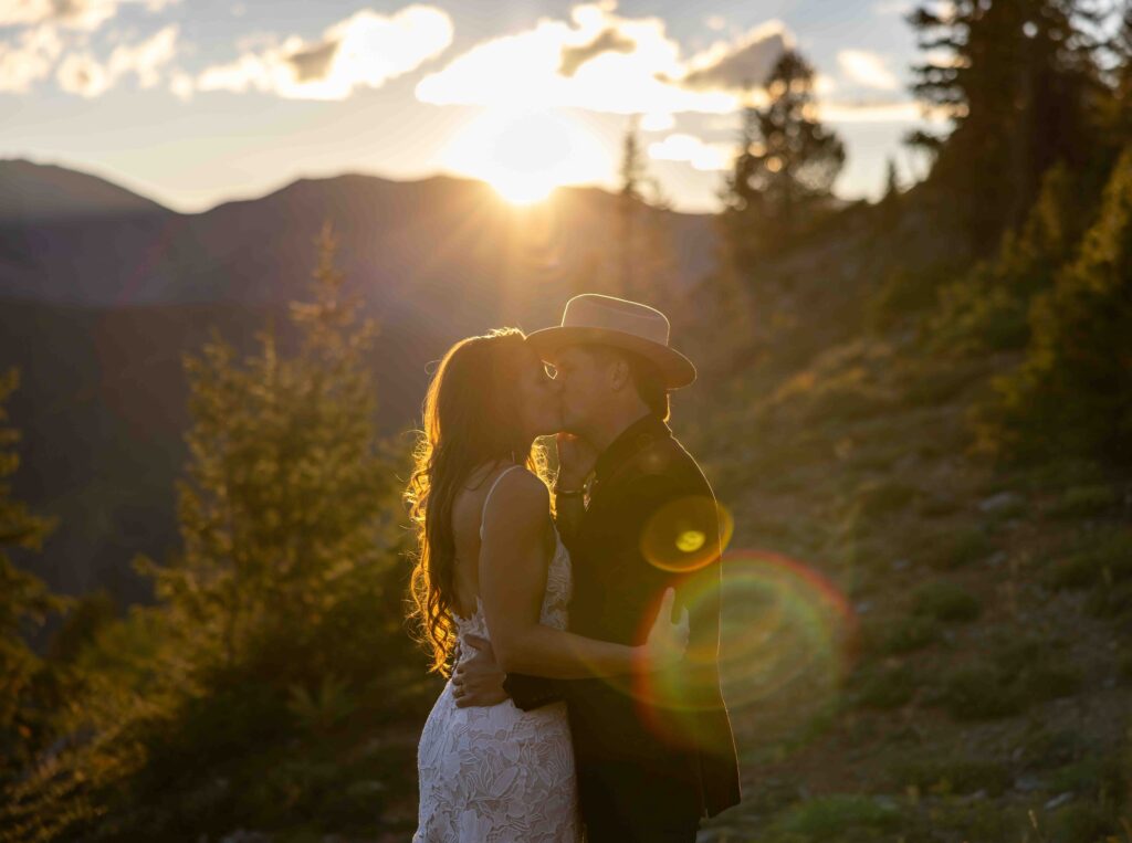 Bride spinning in her wedding dress in front of the mountain peaks
