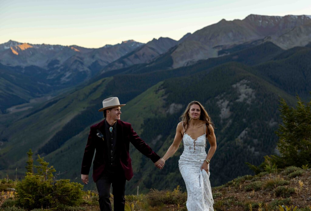 Groom lifting the bride in a joyful embrace at sunset
