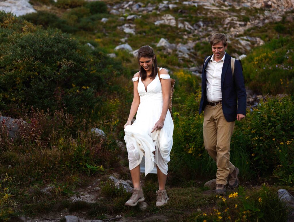 Dramatic shot of the couple framed by the rugged mountain landscape.
