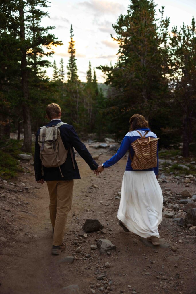 Bride and groom embracing with the stunning Colorado mountains behind them.