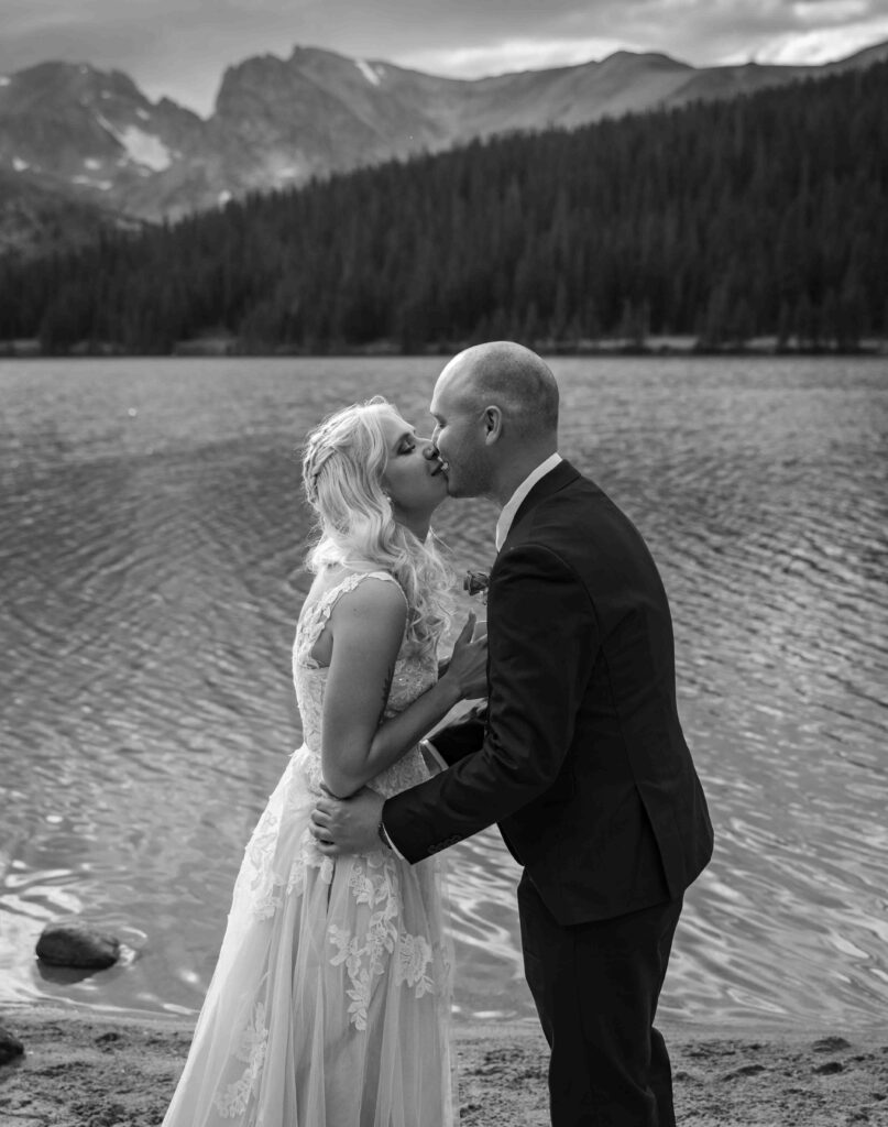 Groom placing the ring on the bride’s finger.