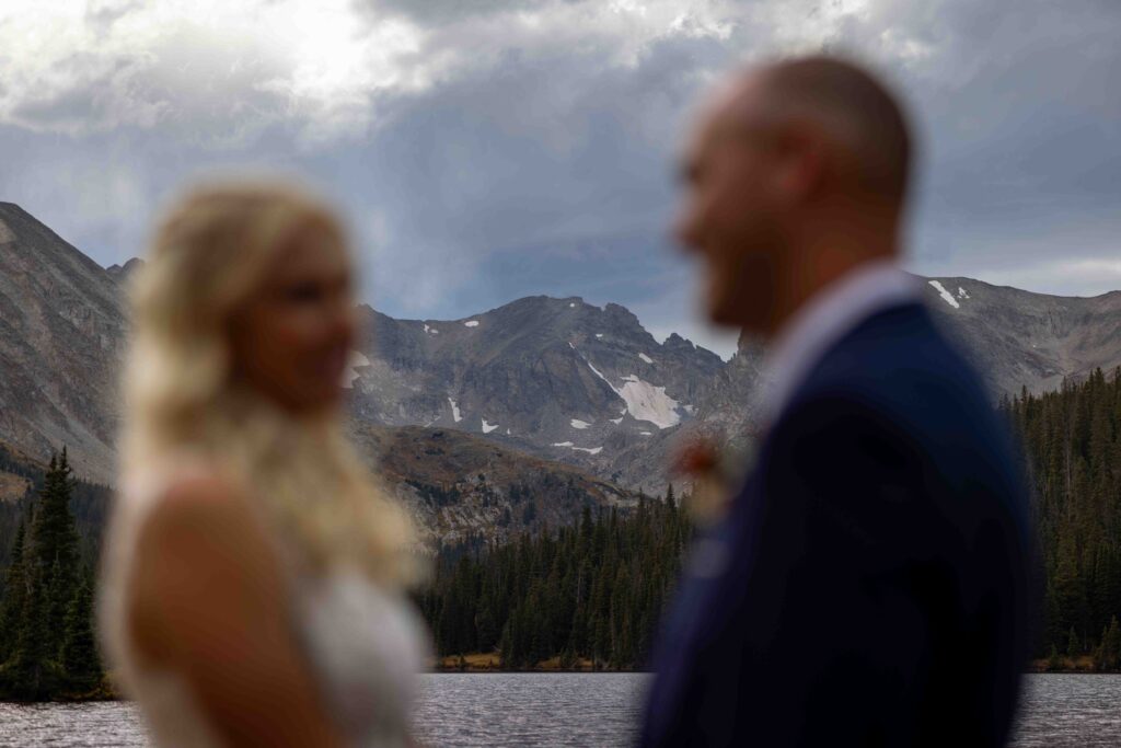 First kiss as newlyweds with the lake behind them.