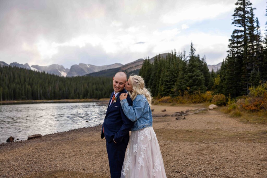 Silhouette shot of the couple with mountains in the background.