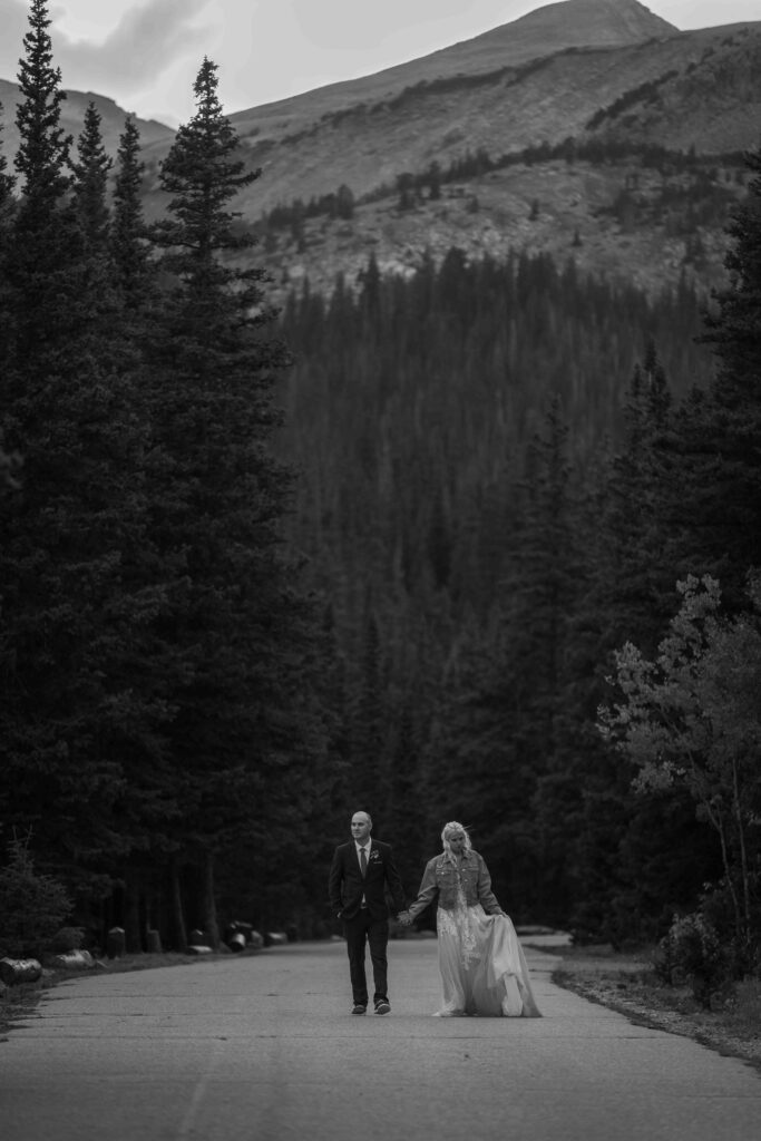 Couple looking into each other’s eyes with the lake behind them.