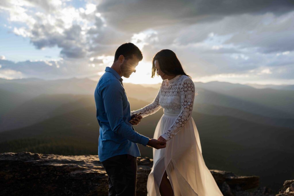 Emotional close-up of the couple holding hands and reading their vows.