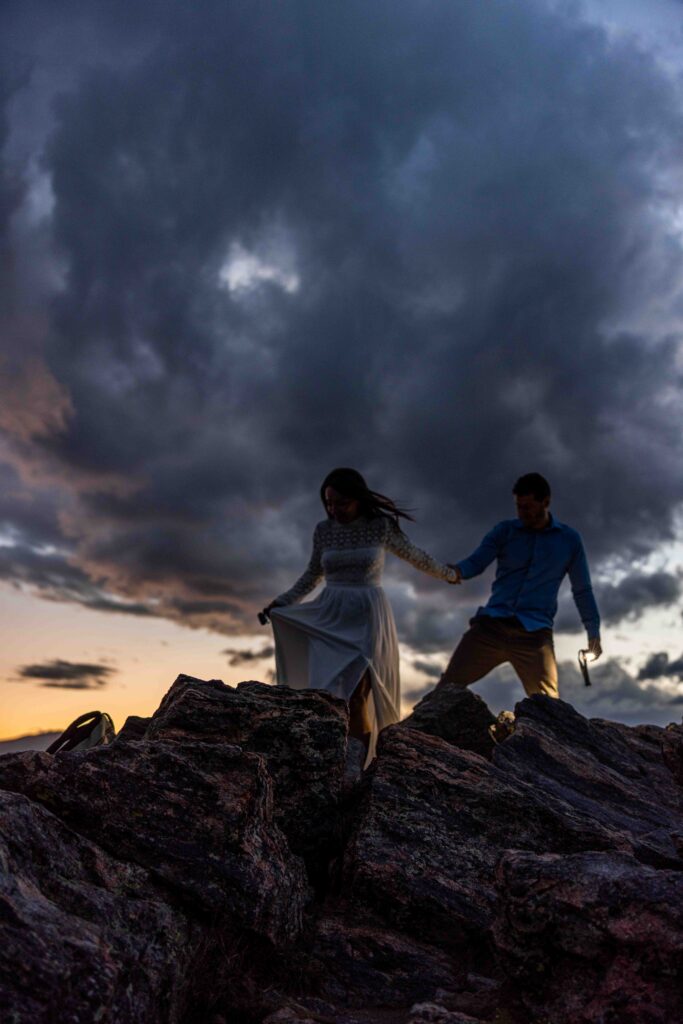 Bride’s veil flowing in the wind with the Rocky Mountains as a backdrop.