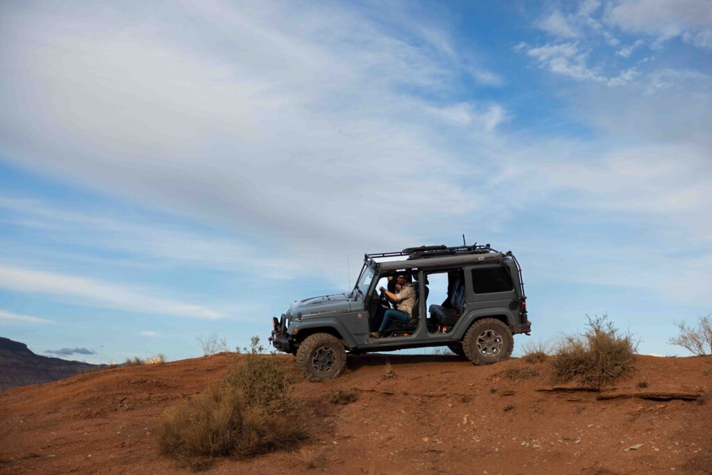 Aerial drone shot of the Jeep parked under a starlit sky