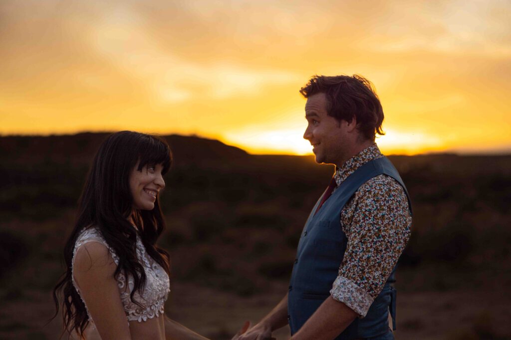 Couple slow dancing under the stars in the Utah desert