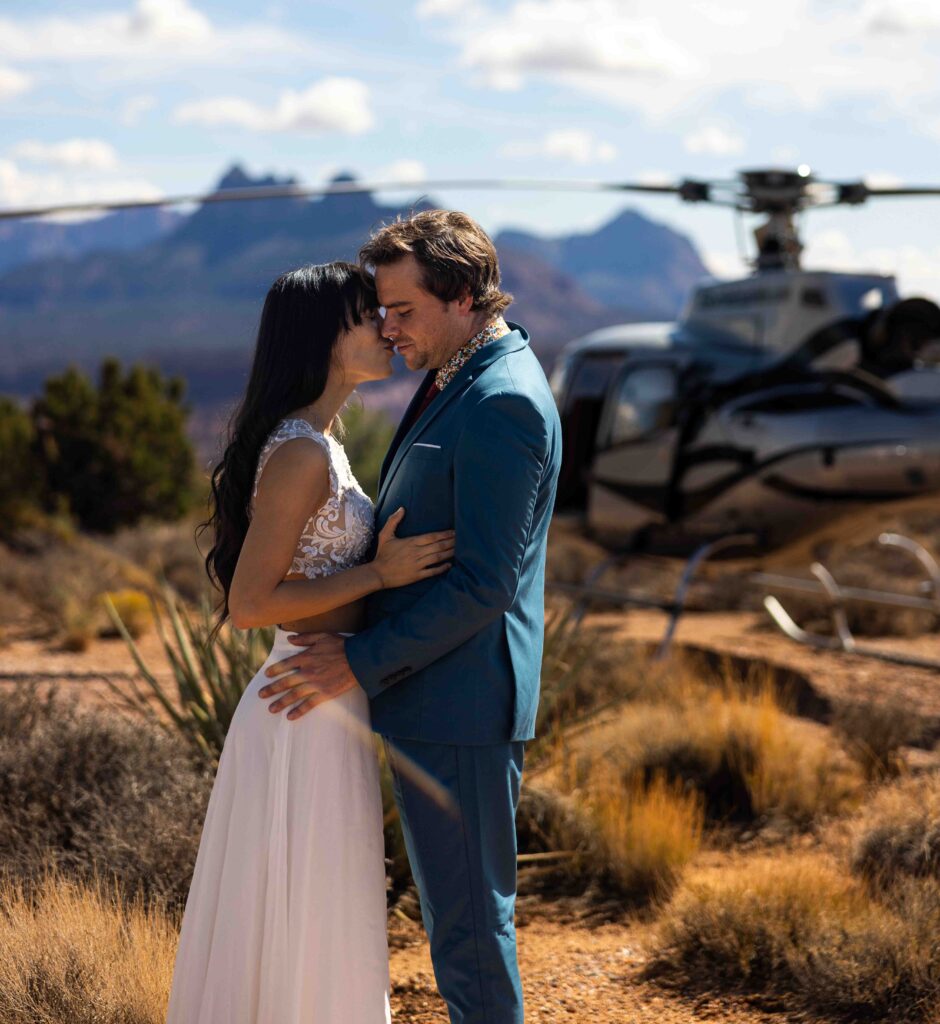 Couple holding hands as they step out onto a remote cliff