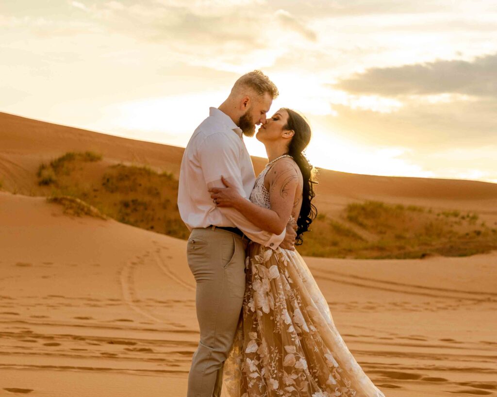 The straight couple sharing an emotional first kiss in the sand dunes