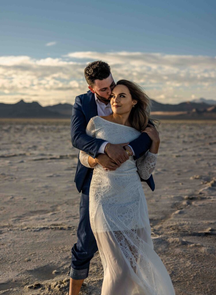 Aerial view of the couple dancing on the expansive white flats