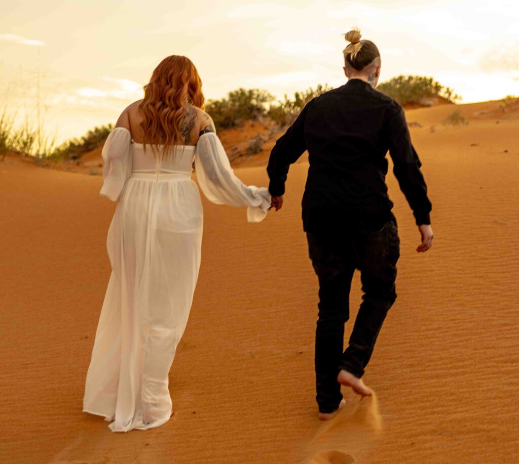 Close-up of an LGBTQ+ couple exchanging vows in the golden desert light