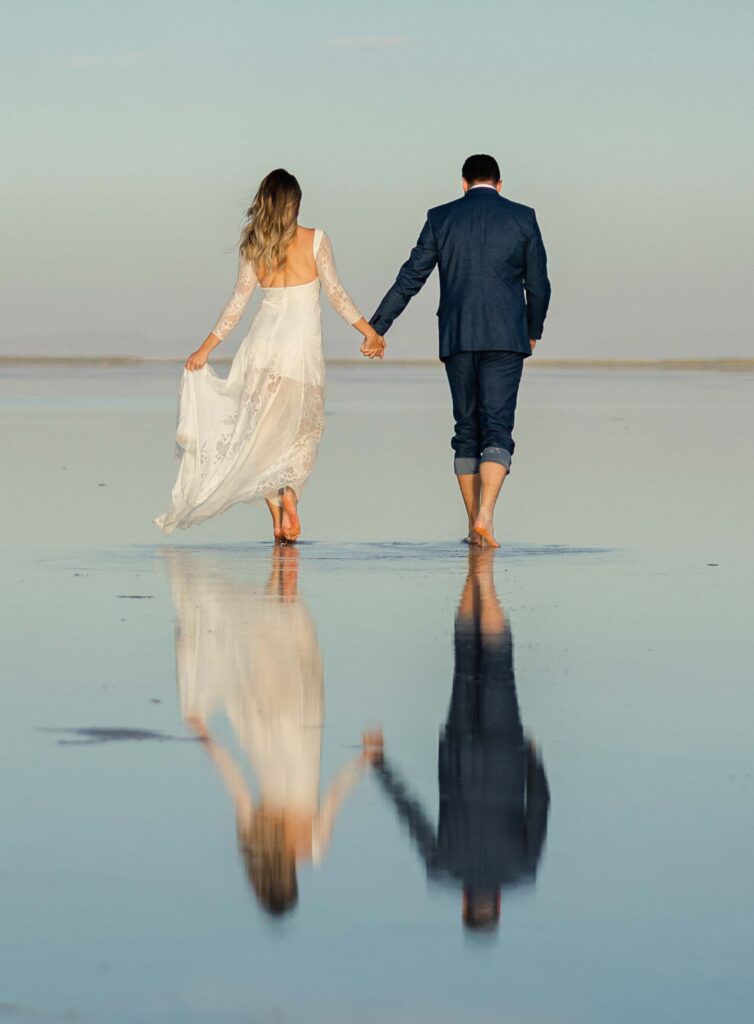 Champagne bottle popping as the couple celebrates their elopement