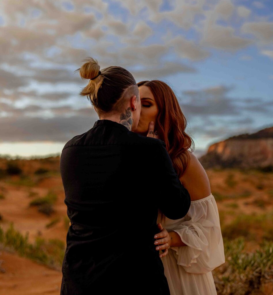 Backlit shot of one couple dancing in the dunes