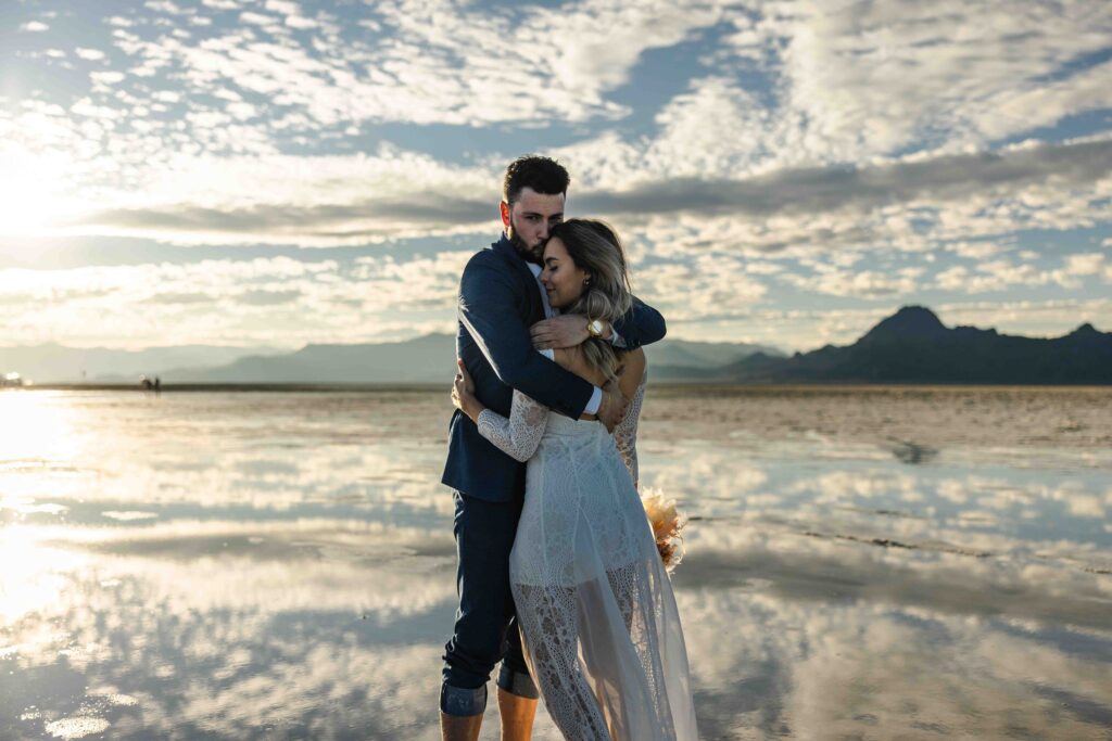 Couple laughing together while barefoot on the salt flats