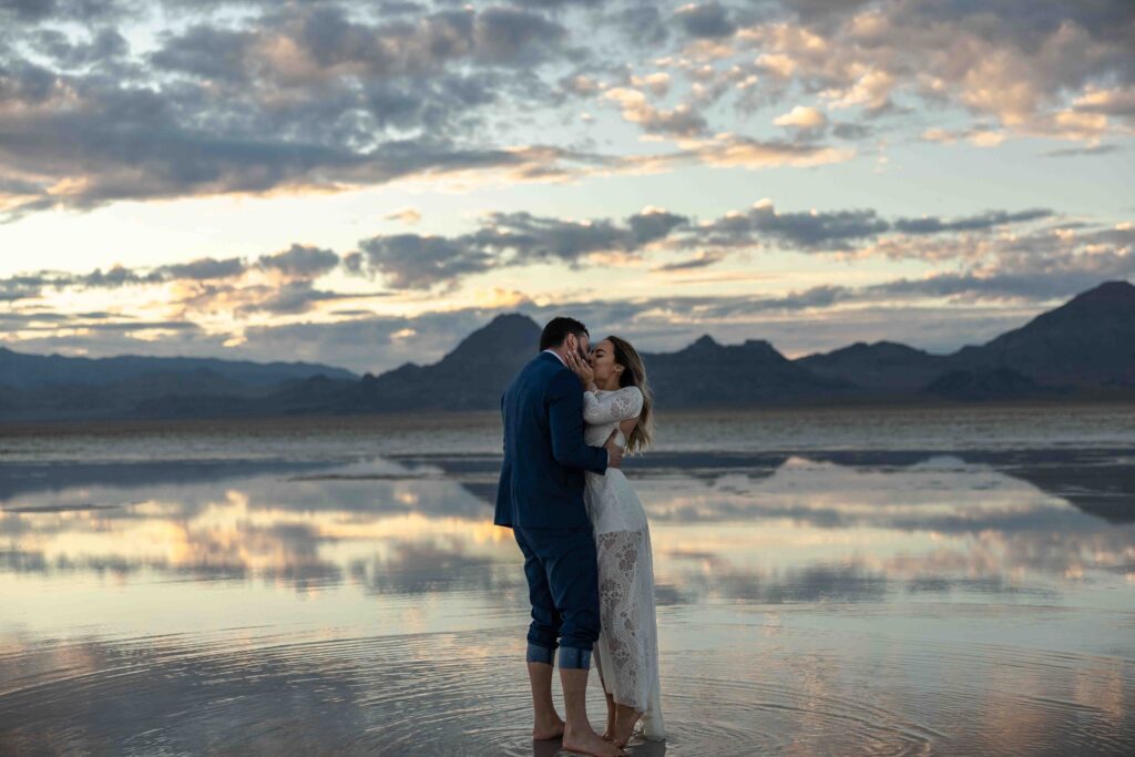 Last light fading as the couple walks toward the horizon, hand in hand