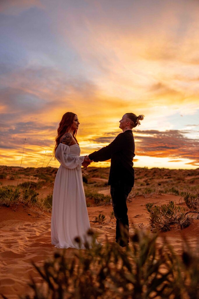 A cozy, intimate moment as the couples sit together on the sand