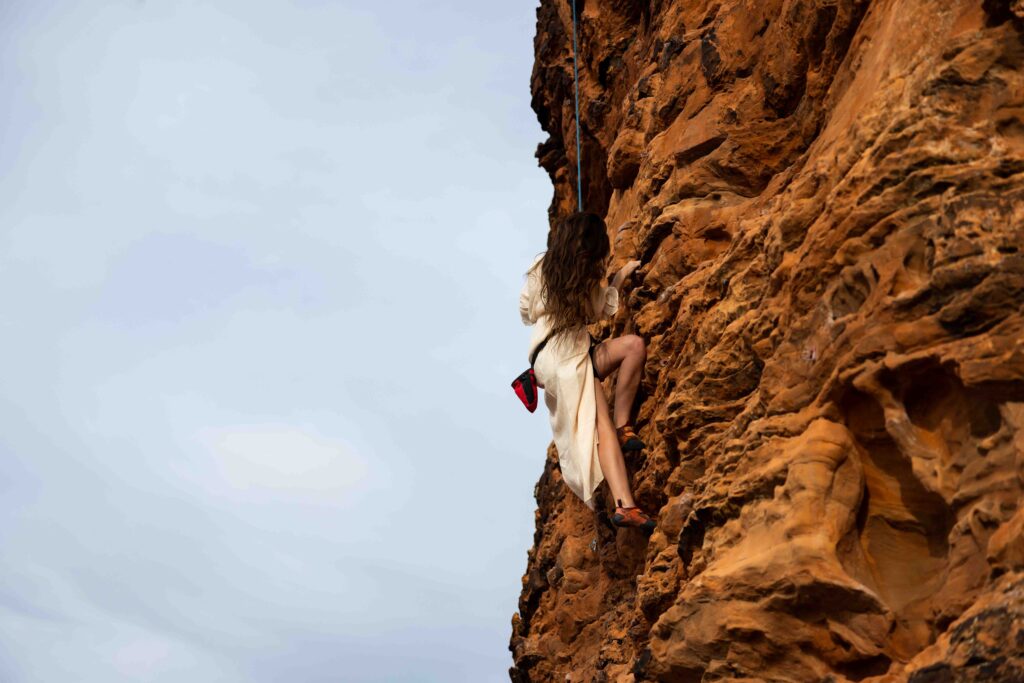 Emotional close-up of the couple smiling at each other while hanging from their harnesses.