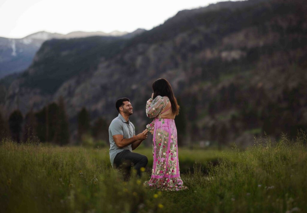 Close-up of the engagement ring with the mountain backdrop.