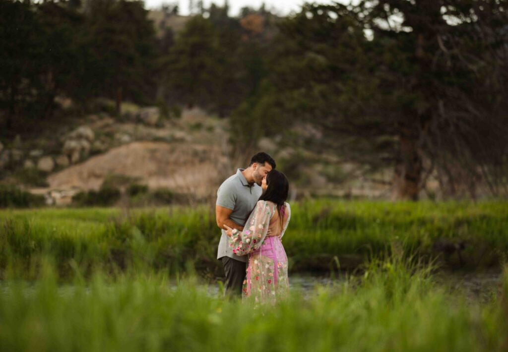 A romantic kiss with the Rocky Mountains in the background.