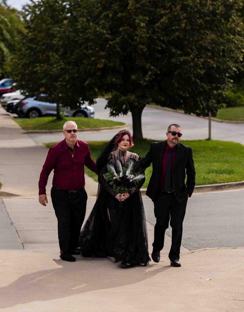 Friends and family sharing a laugh while helping the bride with her dress
