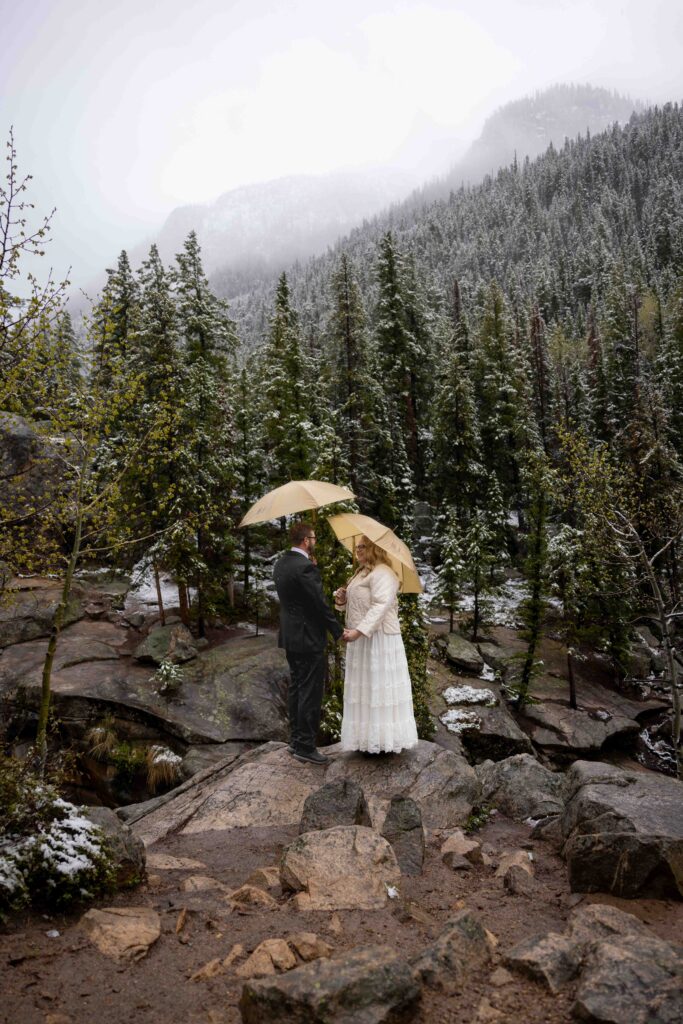 Snow-covered mountains along Independence Pass with a couple standing at a scenic overlook
