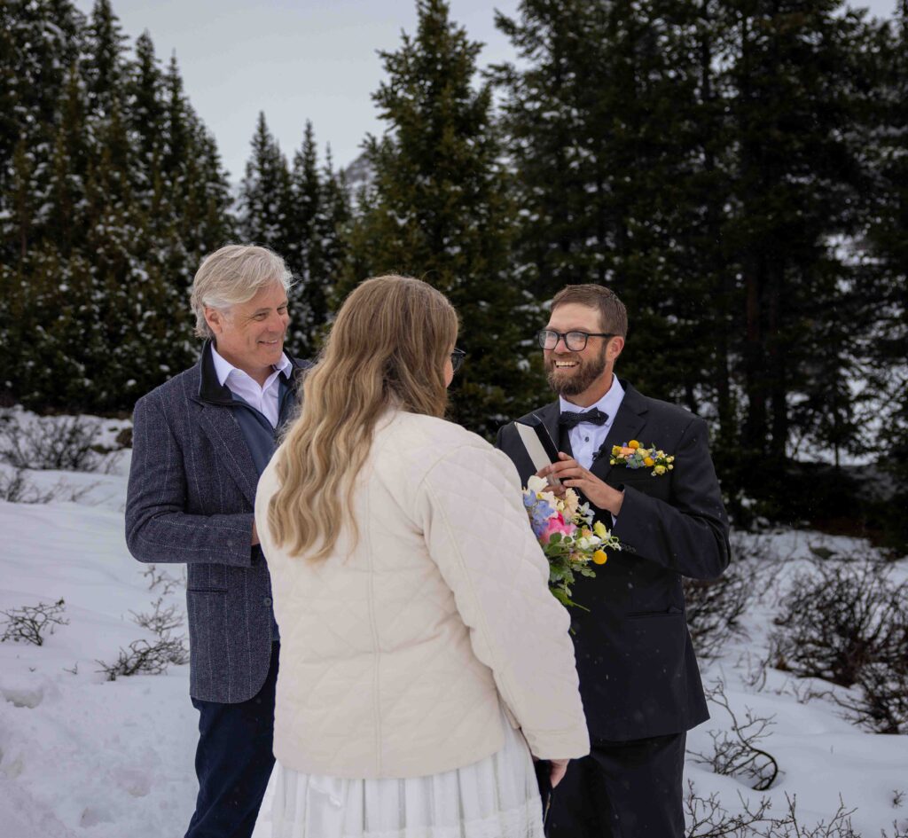 Newlyweds laughing together in the car on the drive back to Aspen
