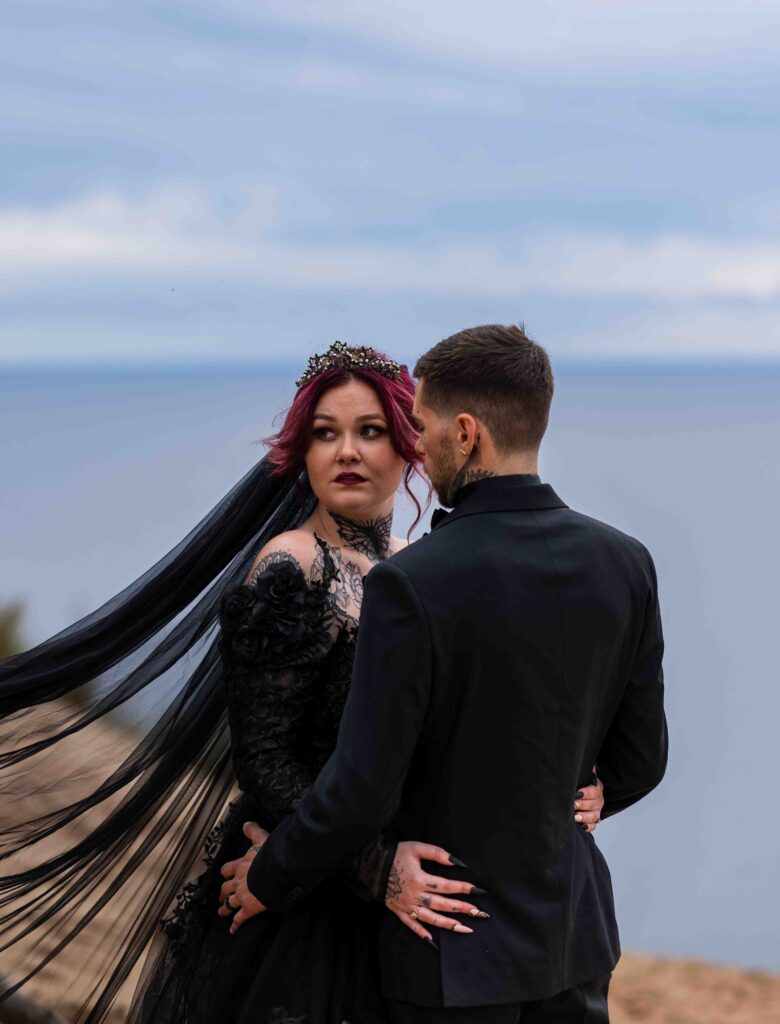 Soft waves rolling onto the sand as the newlyweds dip their toes into the lake
