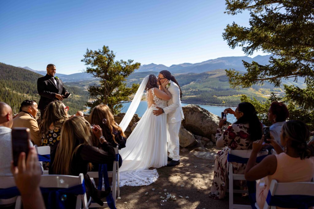 Bride and groom laughing during their reception toast.