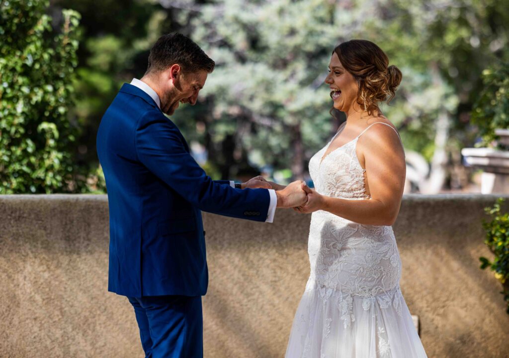 Handwritten vows resting on a rustic wooden table with a bouquet beside them
