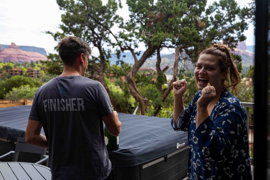 Bride sipping coffee on the Airbnb patio with Sedona’s red rock views in the background
