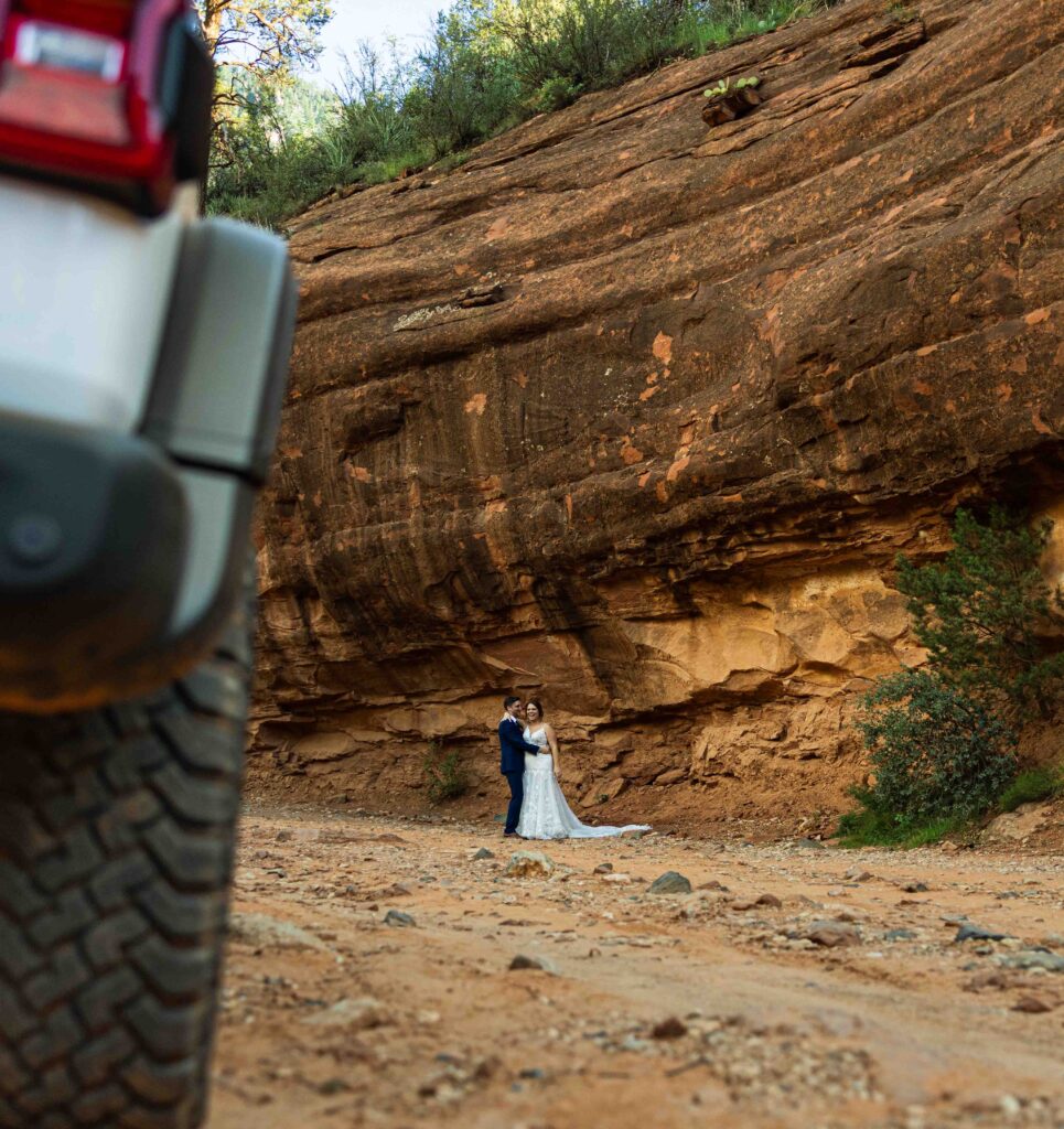 Jeep kicking up dust as it navigates a rugged Sedona trail
