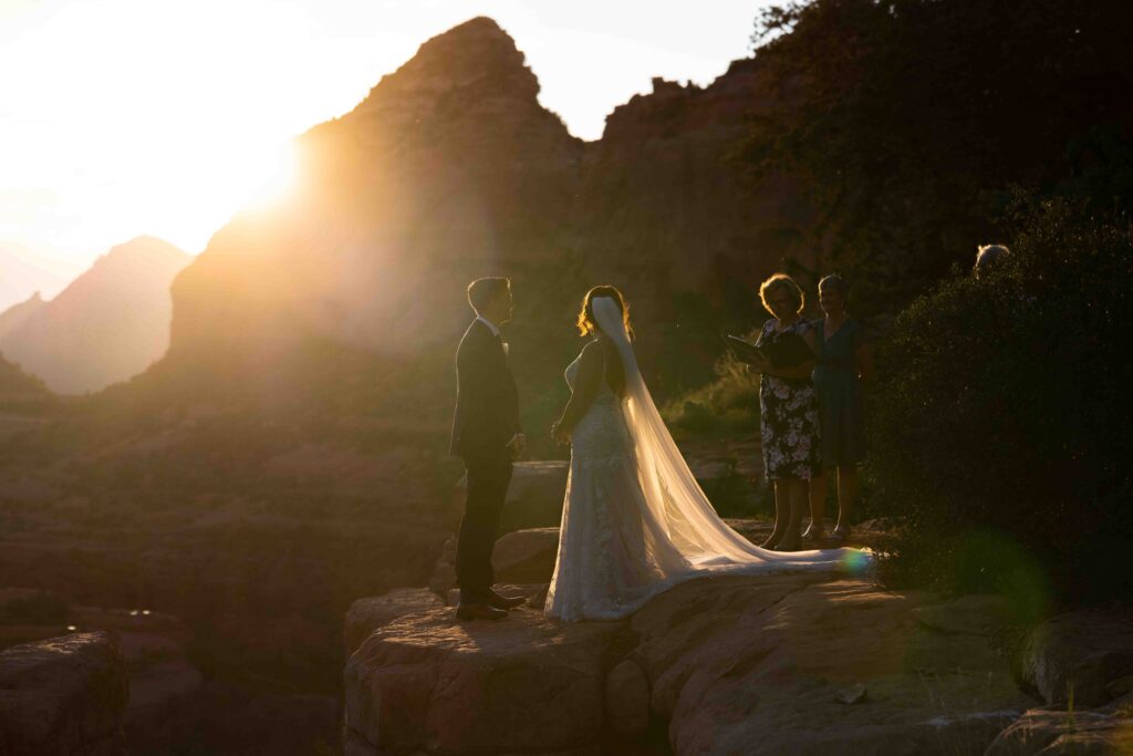 Groom reading his vows while the golden sun casts a warm glow on the couple
