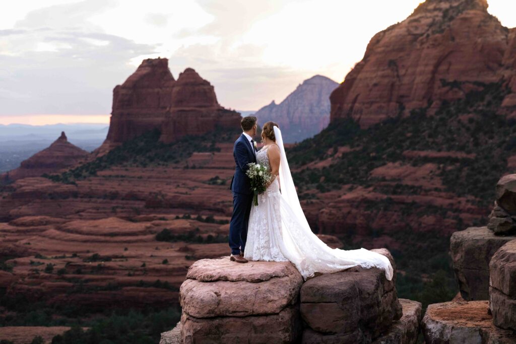 Wedding rings placed on a rock with Sedona’s famous red cliffs in the background
