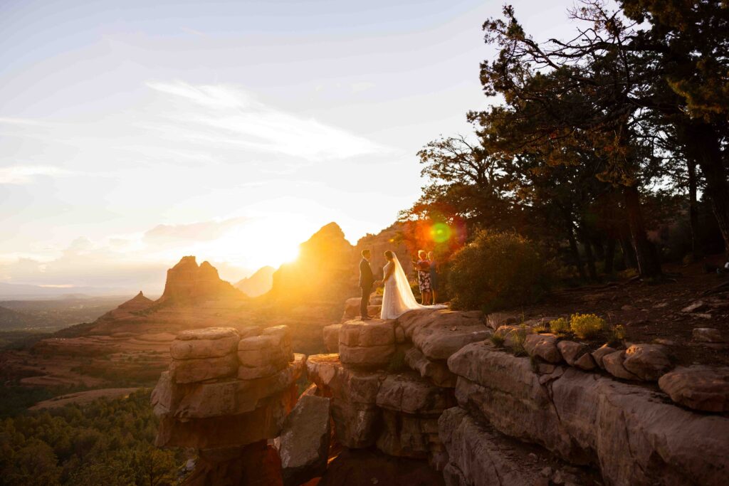 Groom lifting the bride playfully as they laugh during golden hour photos
