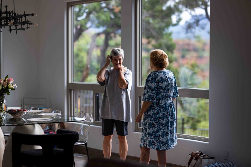 Couple laughing while making breakfast in a cozy Sedona Airbnb kitchen
