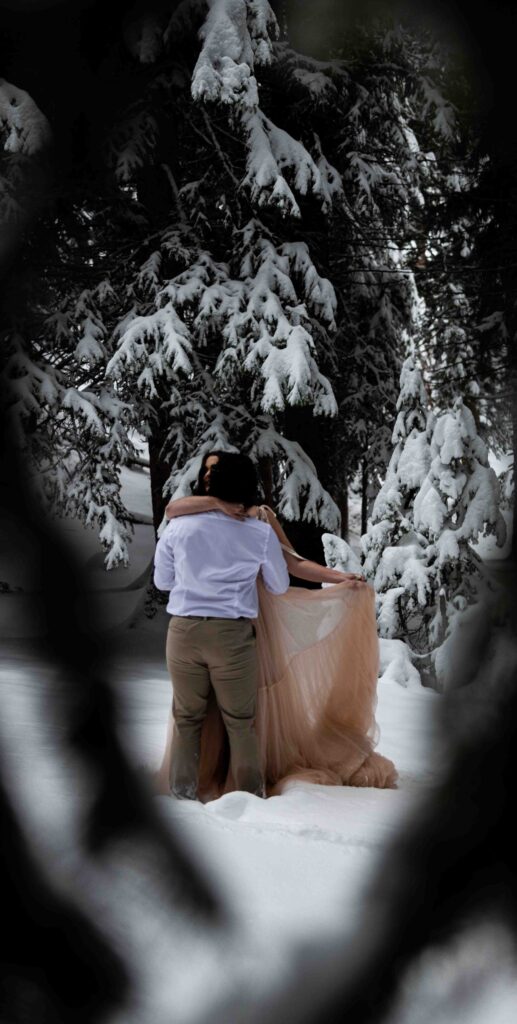 Couple sharing laughter while throwing snow into the air