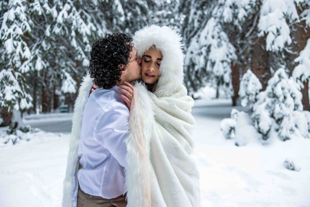 Joyful moment of the couple running hand in hand through the snow